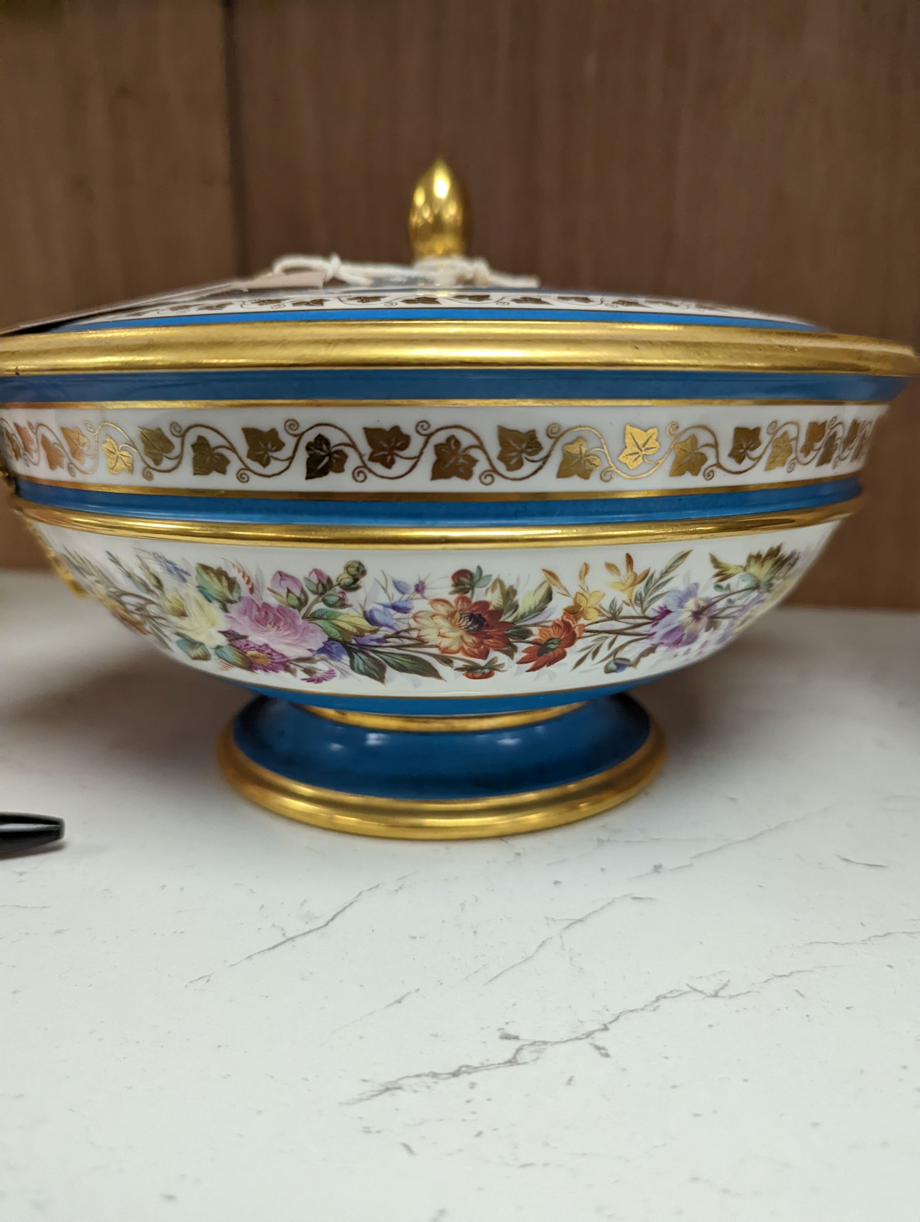 Sevres ecuelle and cover painted with a band of flowers surrounding the gilt monogram of Louis Phillipe, blue mark dated 1850, red mark for Chateau de Compiegne 25cm